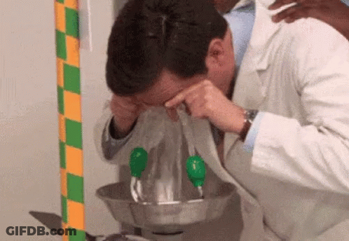 A Man In A Lab Coat Is Washing His Eyes In A Bowl Of Water GIF