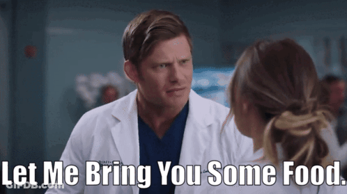 Man In Lab Coat Offering Food GIF