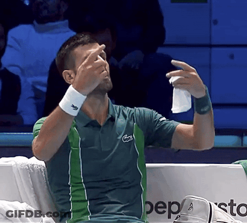 A Man In A Lacoste Shirt Wipes His Nose GIF