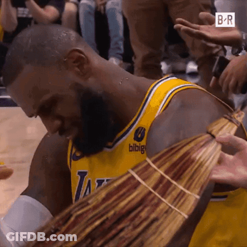 A Man In A Lakers Jersey Is Holding A Bunch Of Money In His Hands GIF