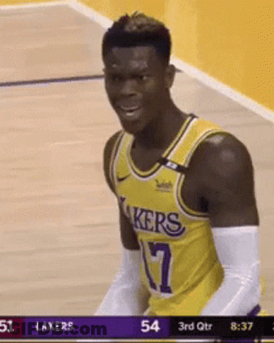 A Man In A Lakers Jersey Is Standing On A Basketball Court . GIF