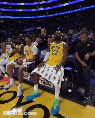 A Man In A Lakers Jersey Sits In The Stands GIF