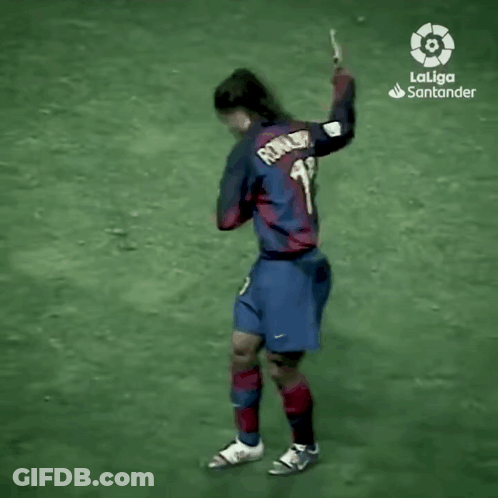 A Man In A Laliga Santander Jersey Is Walking On A Field . GIF