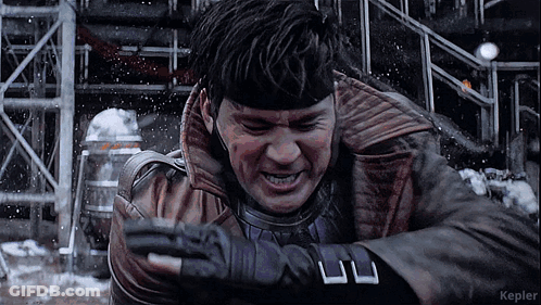 A Man In A Leather Jacket And Gloves Is Standing In The Snow With Kepler In The Corner GIF