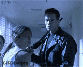 A Man In A Leather Jacket Is Holding A Woman 'S Neck In A Hallway With A 4Gifs.com Watermark GIF