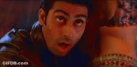 A Man In A Leather Jacket Is Looking At A Woman 'S Feet And Making A Funny Face . GIF