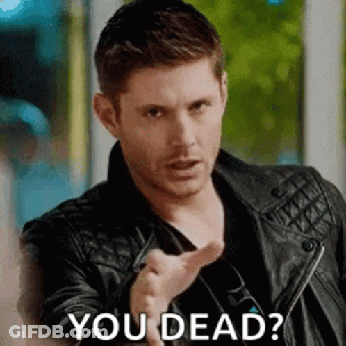 A Man In A Leather Jacket Is Pointing At The Camera And Asking If He Is Dead . GIF