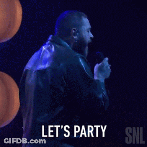 A Man In A Leather Jacket Is Singing Into A Microphone And Says Let 'S Party Snl GIF