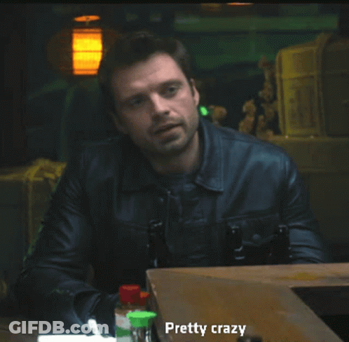 A Man In A Leather Jacket Is Sitting At A Table With Bottles And Says Pretty Crazy GIF