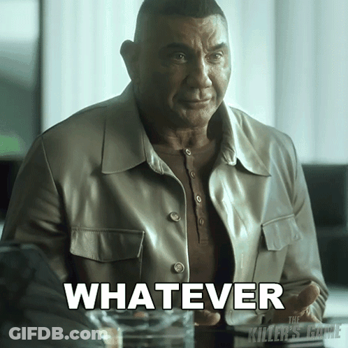 A Man In A Leather Jacket Is Sitting At A Table With The Word Whatever In White Letters GIF