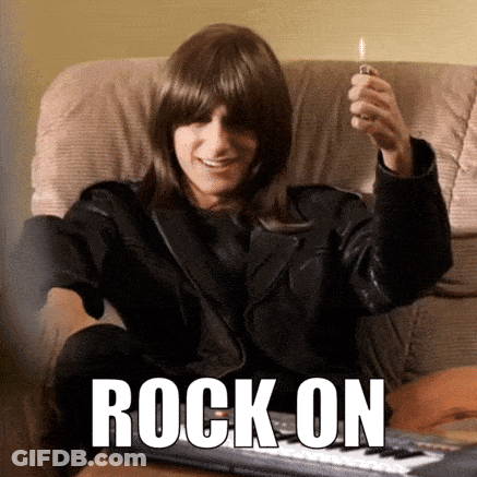 A Man In A Leather Jacket Is Sitting On A Couch Holding A Lighter And The Word Rock On Is On The Bottom GIF