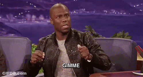A Man In A Leather Jacket Is Sitting On A Couch With His Hands In The Air And The Word Gimme Written On The Screen . GIF