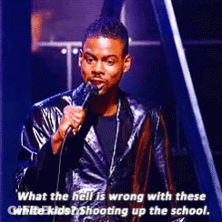 A Man In A Leather Jacket Is Speaking Into A Microphone . GIF