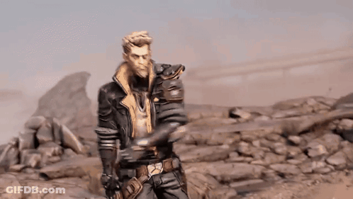 A Man In A Leather Jacket Is Standing In A Rocky Desert . GIF