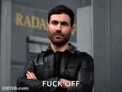 A Man In A Leather Jacket Is Standing In Front Of A Building With His Arms Crossed And Says Fuck Off . GIF