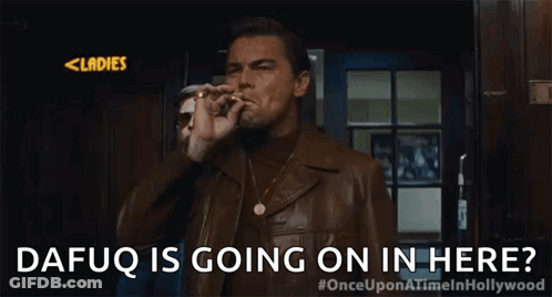 A Man In A Leather Jacket Is Standing In Front Of A Door And Asking If Dafuq Is Going On In Here . GIF