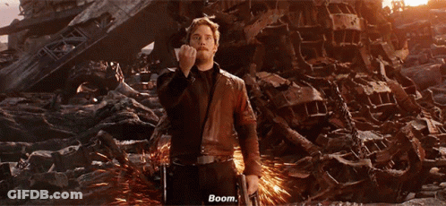 A Man In A Leather Jacket Is Standing In Front Of A Pile Of Junk And Says Boom GIF