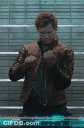 A Man In A Leather Jacket Is Standing In Front Of A Screen With Numbers On It . GIF