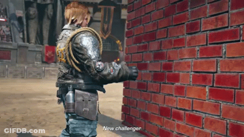 A Man In A Leather Jacket Is Standing Next To A Brick Wall And Says New Challenger GIF