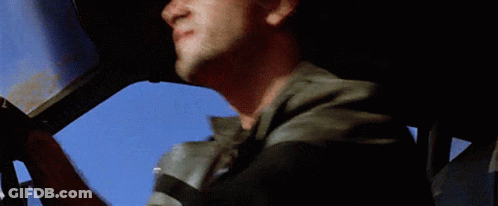 A Man In A Leather Jacket Looks Out Of The Window Of A Car GIF