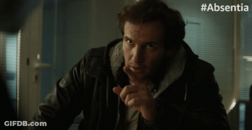 A Man In A Leather Jacket Says Thank You With His Finger On His Lips GIF