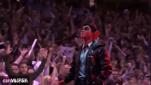 A Man In A Leather Jacket Stands In Front Of A Crowd With The Word Vlipsy On The Bottom GIF