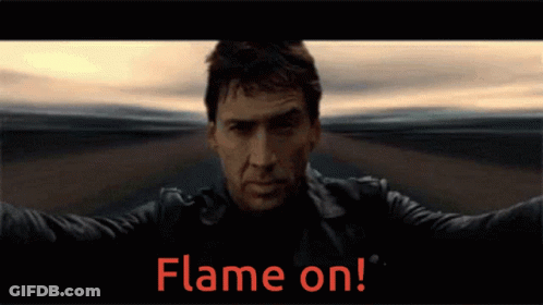 A Man In A Leather Jacket Stands In Front Of A Flame On Sign GIF