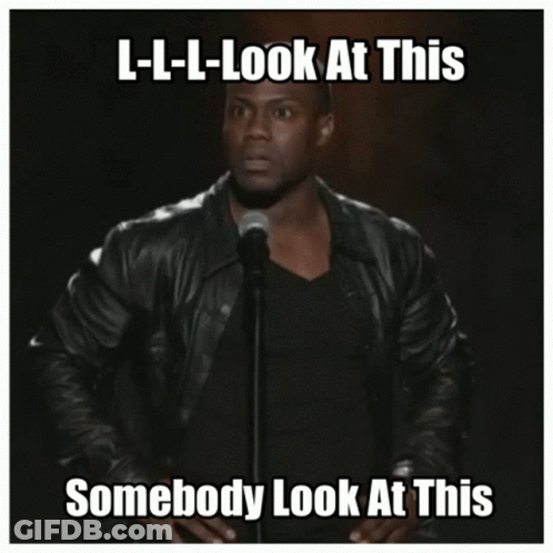 A Man In A Leather Jacket Stands In Front Of A Microphone With The Caption L-L-L-Look At This GIF