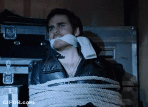 A Man In A Leather Jacket Tied Up With Rope GIF