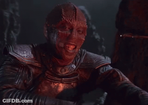 A Man In A Leather Jacket With A Red Mask On His Face GIF