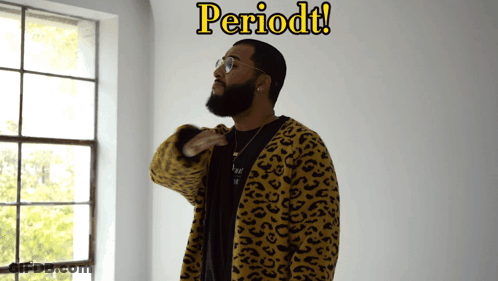 A Man In A Leopard Print Jacket Stands In Front Of A Window With The Word Periodt Written Above Him GIF