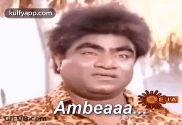 A Man In A Leopard Print Shirt Is Making A Funny Face And Says Ambeaaa . GIF