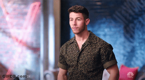 A Man In A Leopard Print Shirt Is Standing In Front Of A Nbc Logo GIF
