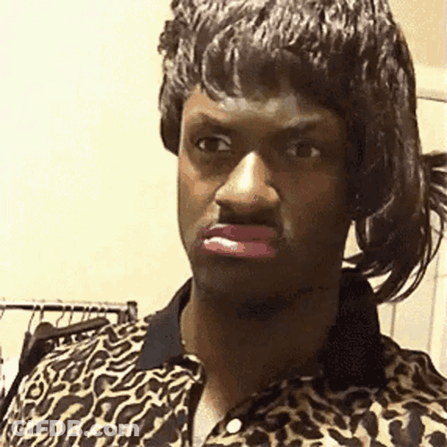 A Man In A Leopard Print Shirt Is Wearing A Wig And Pink Lipstick . GIF