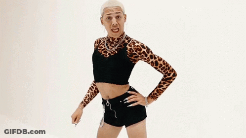 A Man In A Leopard Print Top Is Flexing His Arm . GIF