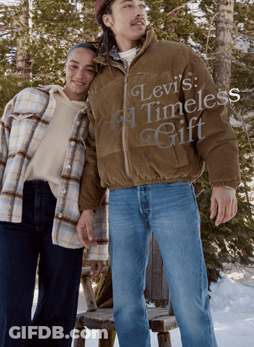 A Man In A Levi 'S Timeless Gift Jacket Stands Next To A Woman In A Plaid Shirt GIF