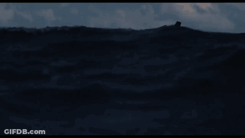 A Man In A Life Preserver Is Floating In The Ocean GIF