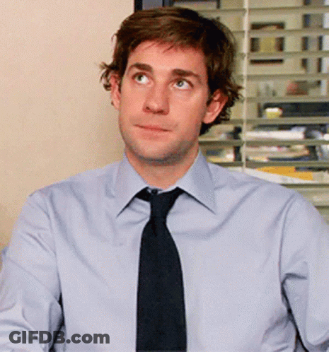A Man In A Light Blue Shirt And Black Tie GIF