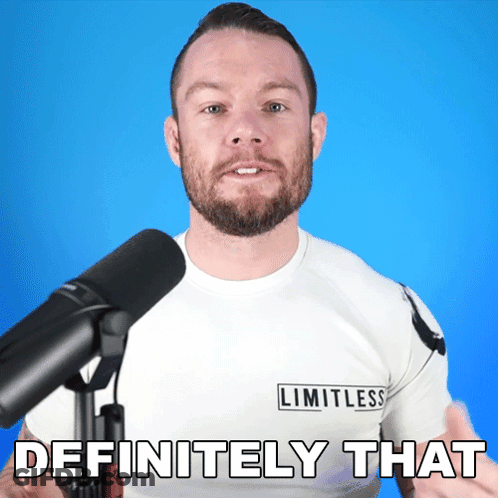A Man In A Limitless Shirt Stands In Front Of A Microphone GIF