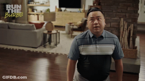 A Man In A Living Room With The Words Run The Burbs On The Bottom Right GIF