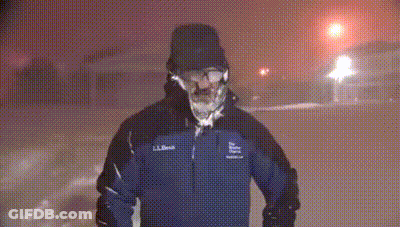 A Man In A Ll Bean Jacket Is Standing In The Snow At Night GIF