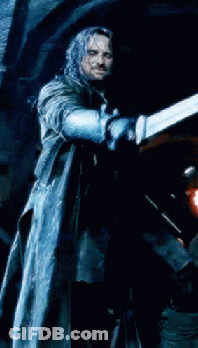 A Man In A Long Coat Is Holding A Blue Object In His Hand GIF