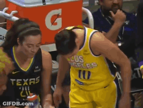 A Man In A Los Angeles Jersey Is Talking To A Woman In A Texas Jersey . GIF