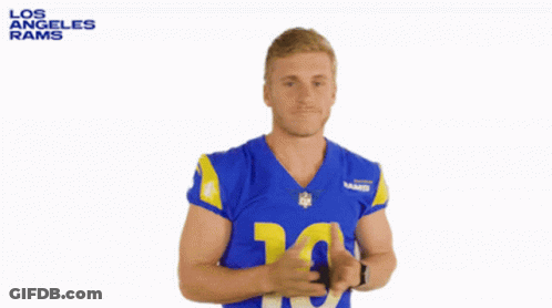 A Man In A Los Angeles Rams Jersey Is Shrugging GIF
