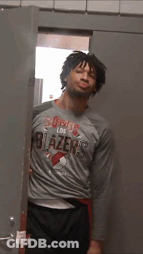 A Man In A Los Blazers Shirt Is Standing In A Doorway GIF