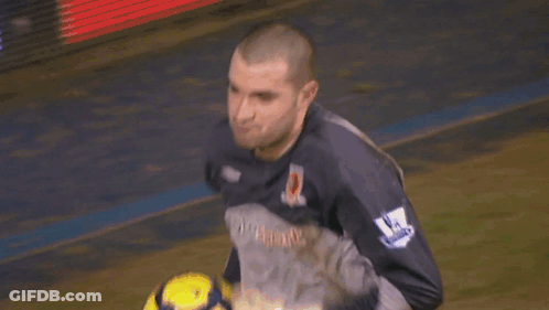 A Man In A Lottosport Jersey Holds A Soccer Ball In His Hands GIF