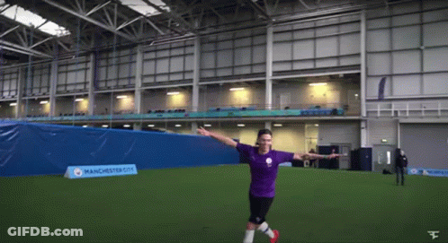 A Man In A Manchester City Jersey Kicks A Soccer Ball On A Field GIF