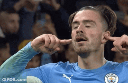 A Man In A Manchester Jersey Covering His Ears With His Fingers GIF