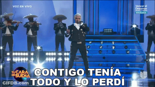 A Man In A Mariachi Outfit Sings Into A Microphone With The Words Contigo Tena Todo Y Lo Perdi Below Him GIF
