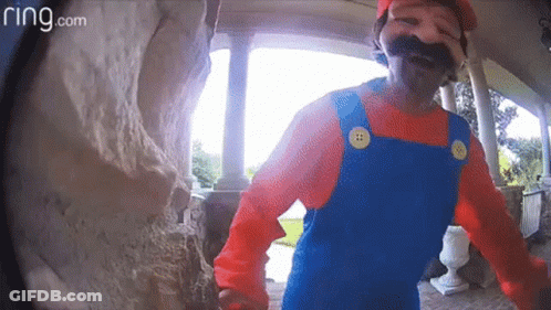 A Man In A Mario Costume Is Standing On A Porch GIF
